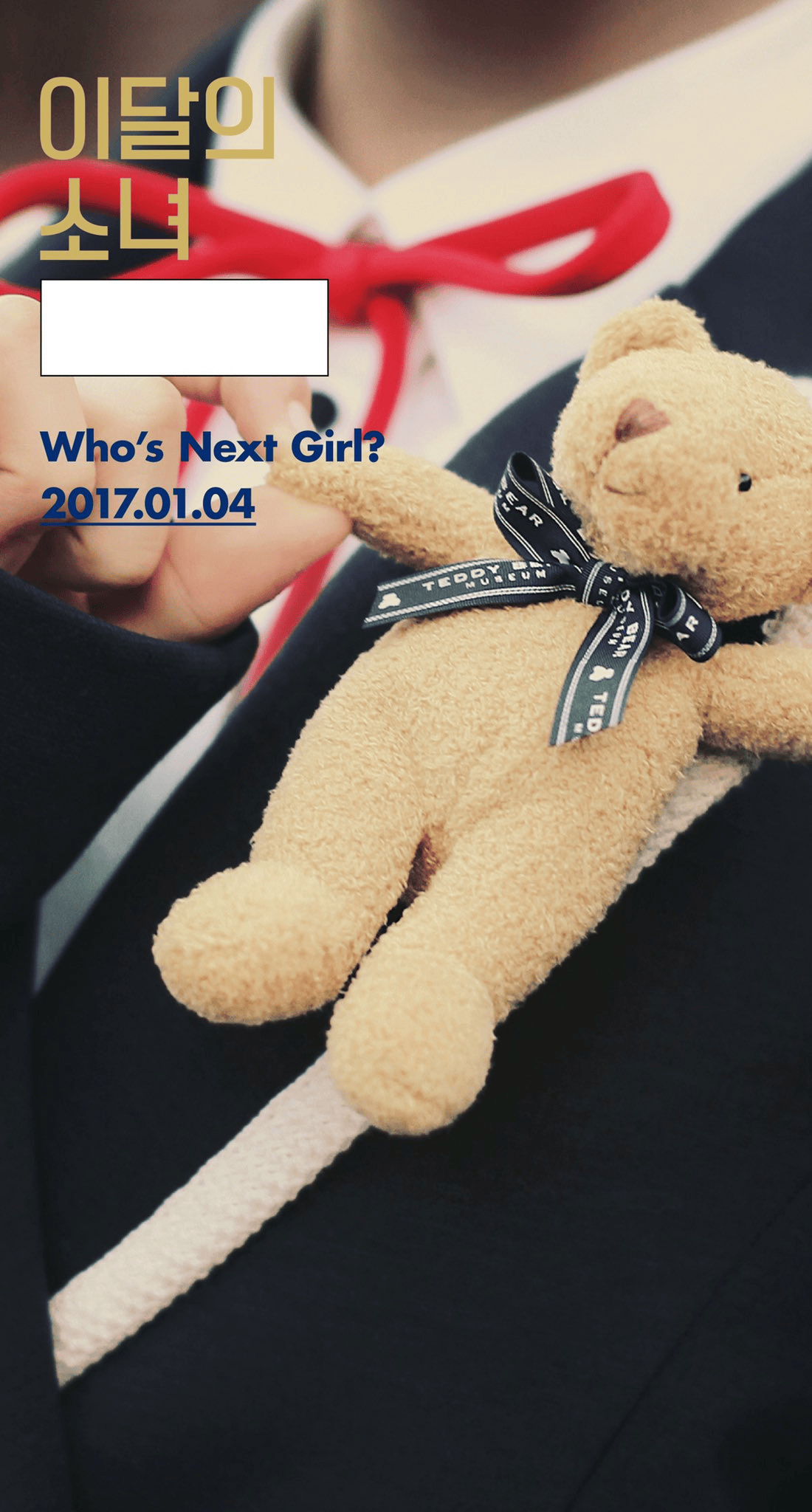 A teddy bear sitting on a girl's shoulder.
